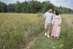 Couple walking and sitting together near tall grass