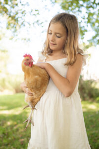 Girl holding a chicken in-home family photography Piedmont, Oklahoma